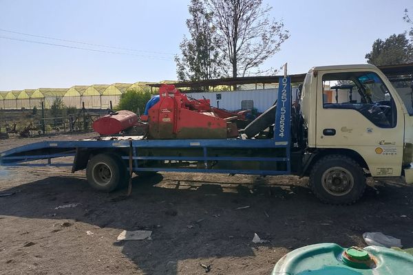 Modern flatbed tow truck with hydraulic tilt system